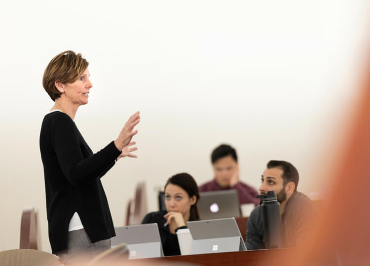 A female nursing instructor speaking to a class