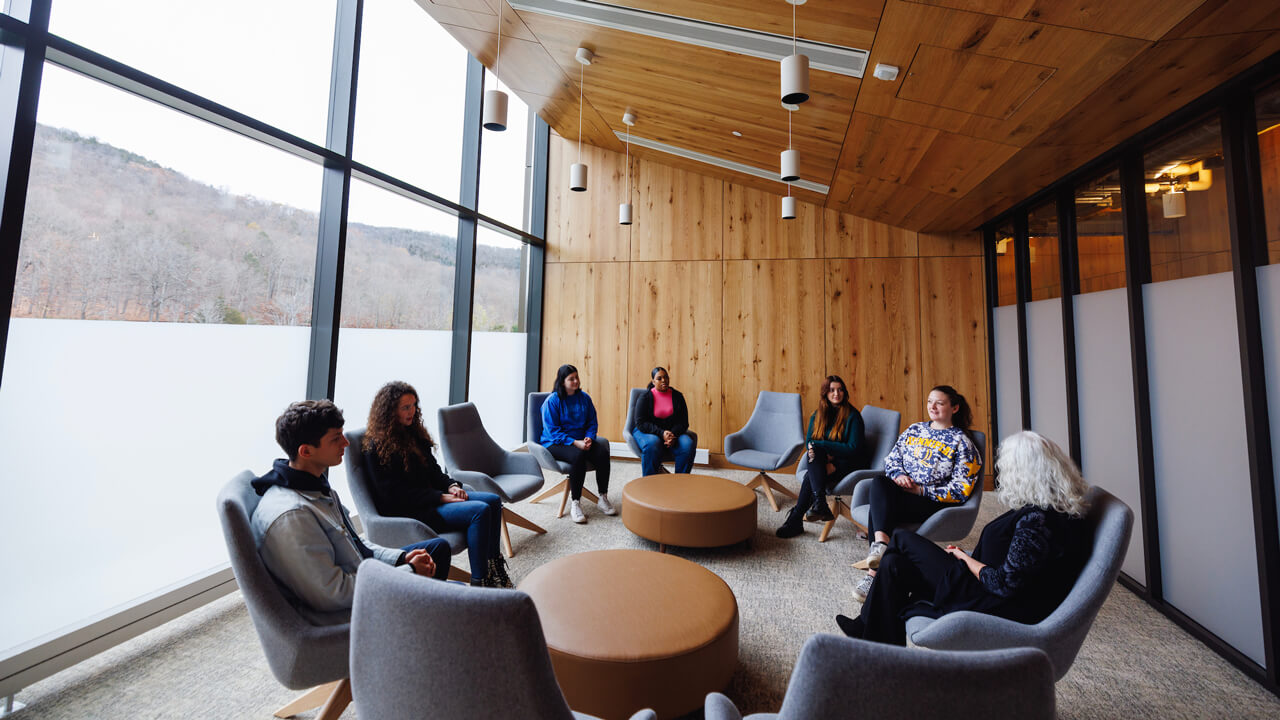 A professor of social work leads a discussion with students.