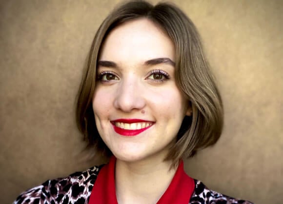 Julia Schnarr smiling against a beige background