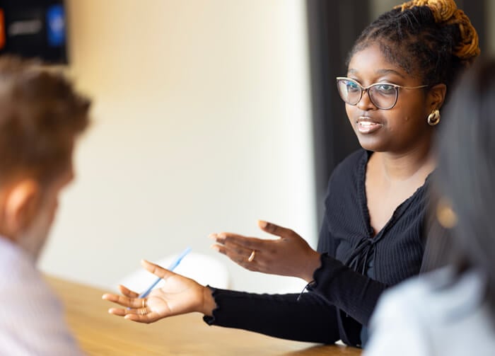 A graduate student collaborating with group members.