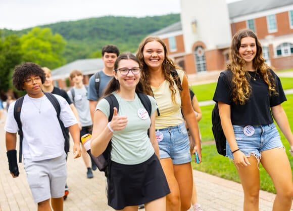 Individuals walking across the Quad at Orientation